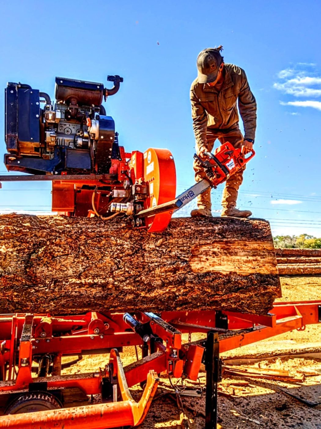Justin trimming a log on the sawmill